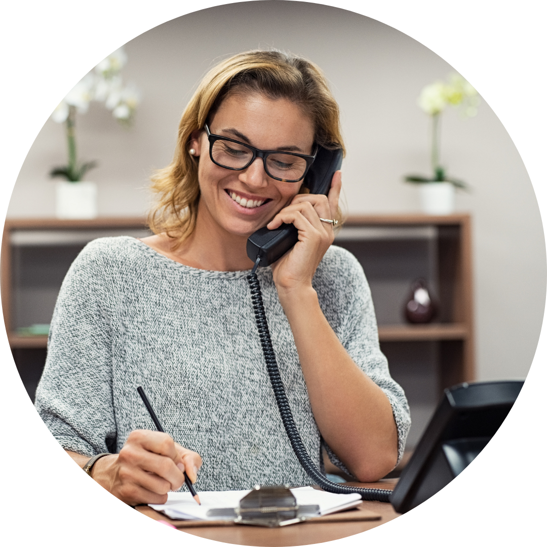 A woman using a phone at a business. Phone Experts offers business phone solutions in Red Deer and all of Alberta. 
